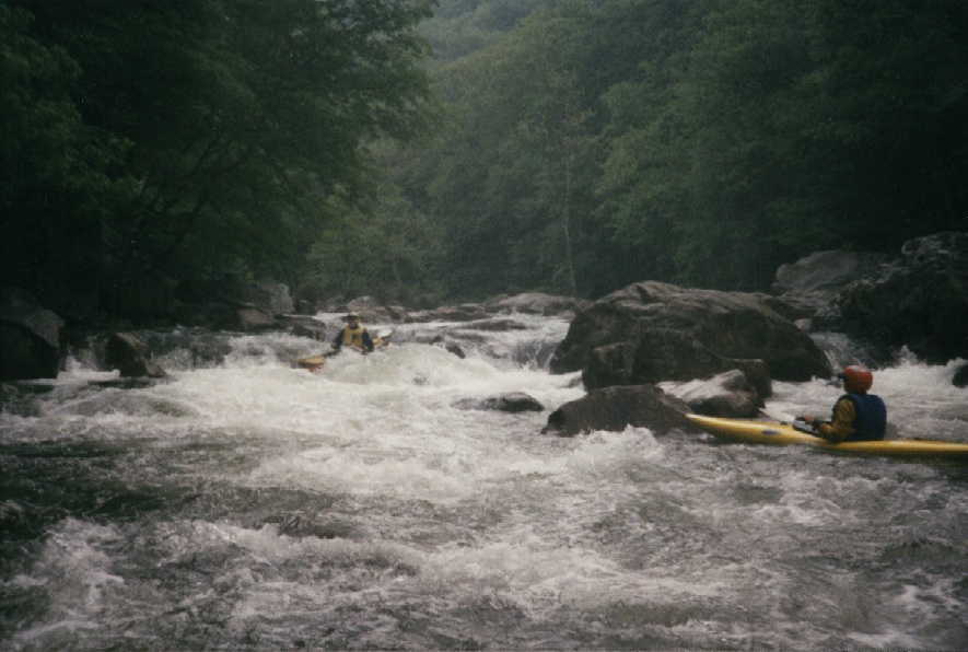 Kim Buttleman running Island Rapid on the Lower Big Sandy @5.4', Keith Merkel in eddy (in 1997)